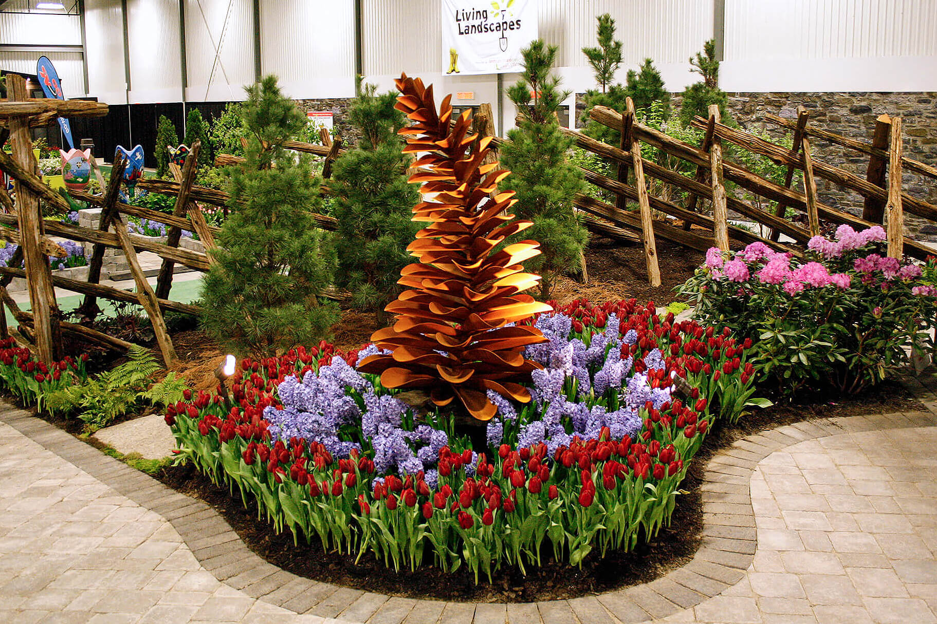 large metal pine cones sculpture in a garden